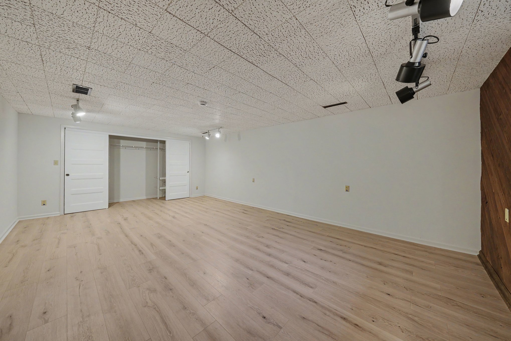 Wide view of a large finished basement room