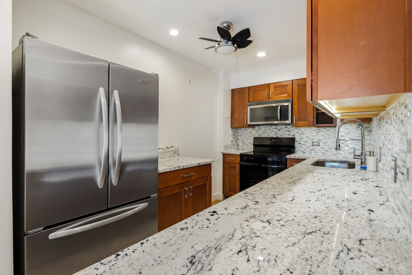 Granite counters and glass-mosaic backsplash